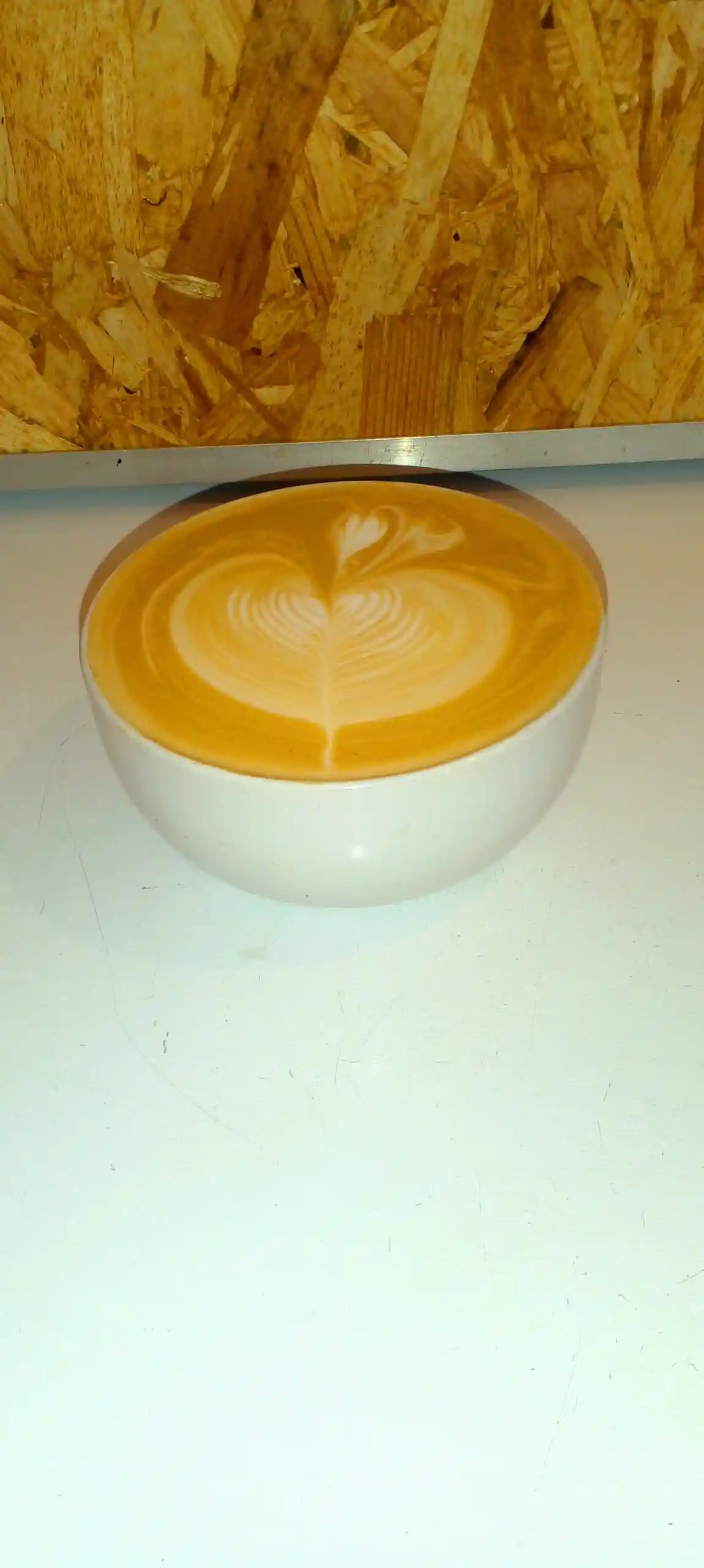 Latte art on the drip tray of a professional espresso machine